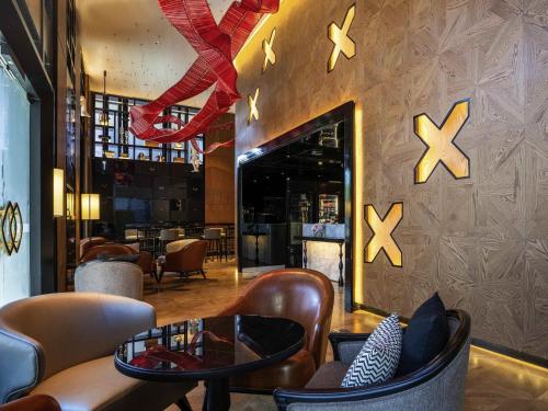 een restaurant met een lobby met stoelen en een open haard bij Sofitel Adelaide in Adelaide