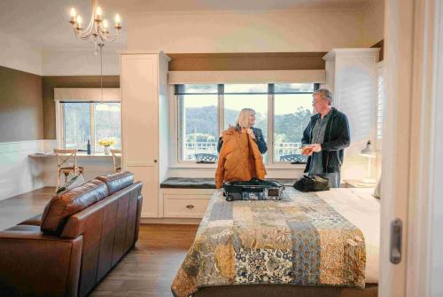 a man and a woman standing in a bedroom at Scenic Marysville in Marysville