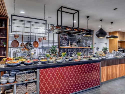 a kitchen with a buffet of food on a counter at Mercure Katowice Centrum in Katowice