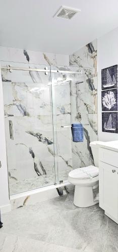 a bathroom with a shower and a toilet at Beach Condo in Clearwater Beach