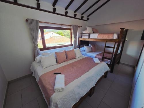 a bedroom with a bed and a bunk bed at Casa Hotel La Morada in Villa de Leyva