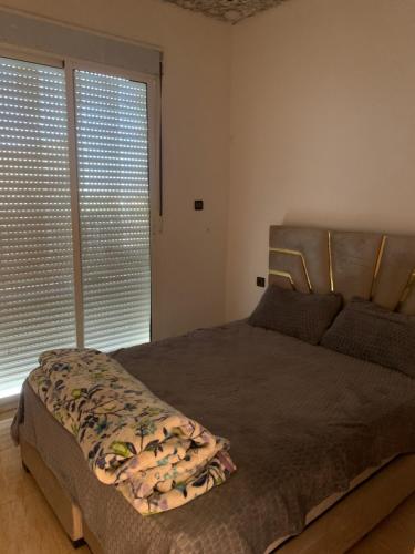 a bedroom with a bed and a large window at Villa Gomez in Sbiti
