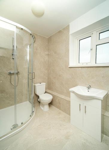 a bathroom with a toilet and a sink and a shower at 5 of 5 Room Cozy, spacious and modern in Camden Town in London