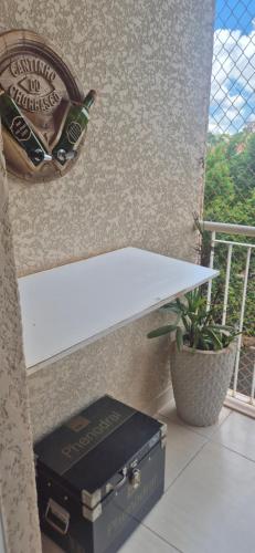 a book sitting on top of a table next to a balcony at Lindo Completíssimo Ap 2 quart Cama King Maq Lavar in Ribeirão Preto