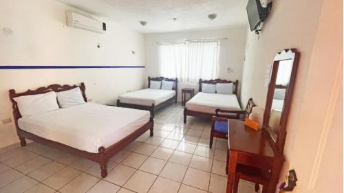 Hotel Hacienda Bacalar tesisinde bir odada yatak veya yataklar