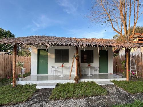 a small house with a thatched roof at Garden Village in El Nido