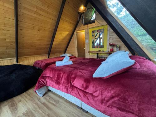 a bedroom with a large bed in a attic at Finca Agrópolis de Silvania in Silvania