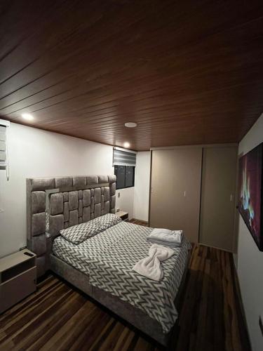 a bedroom with a large bed with a headboard at Apto Domus in Pamplona