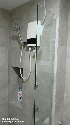 a shower with a shower head in a bathroom at Mesahill Premier Suite-Wi-Fi-NETFLIX in Nilai