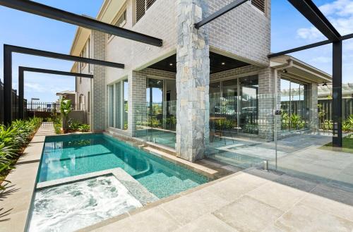 a swimming pool in the backyard of a house at Luxury 4BR Retreat with Pool & Private Spa Bath in Marsden Park