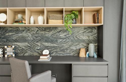 a desk in a room with a stone wall at Luxury 4BR Retreat with Pool & Private Spa Bath in Marsden Park