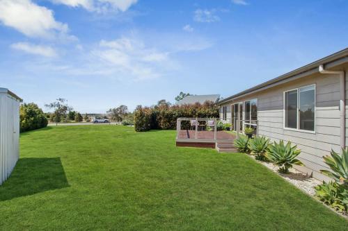 a backyard of a house with a lawn at Wellington Waters in Wellington East