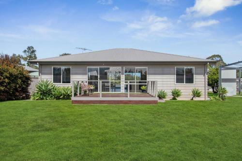 a house with a green lawn in front of it at Wellington Waters in Wellington East