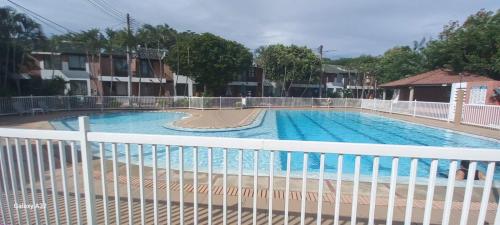 a swimming pool with a white fence around it at Acogedor Apartamento Girardot in Girardot