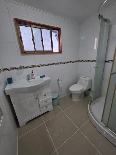 a bathroom with a sink and a toilet and a shower at Casa Flor del aire in La Serena