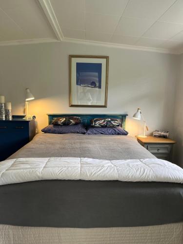 a bedroom with a large bed with two pillows at Portobello Bach Double Cove in Lochmara Bay