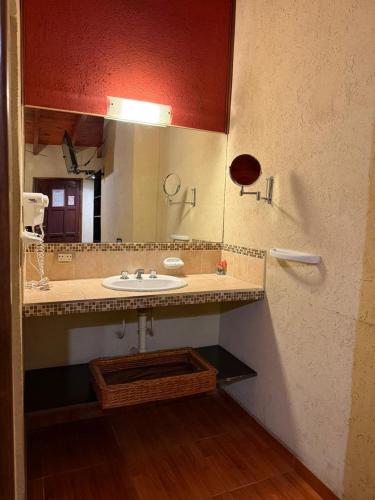 a bathroom with a sink and a mirror at Hotel Ideal vcp in Villa Carlos Paz