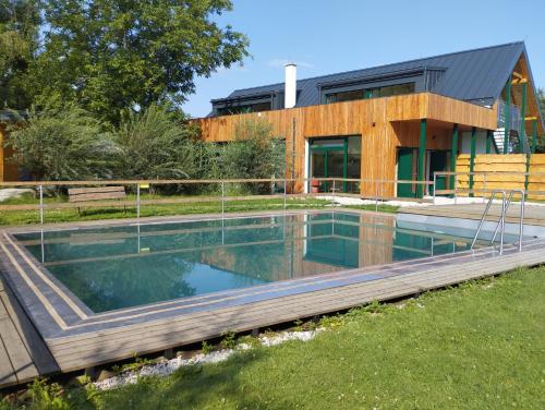 a swimming pool in front of a house at Dobromil - Camp pod kaštany in Morávka