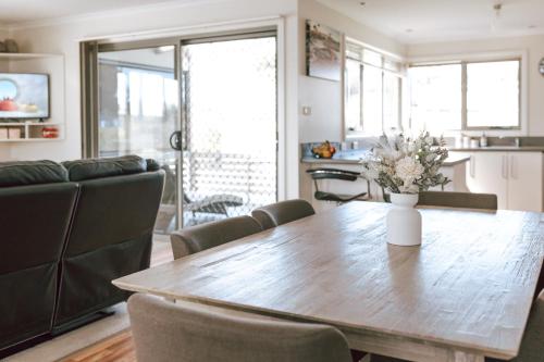 a kitchen and dining room with a wooden table and chairs at Mara House - Space for Everyone in St Helens