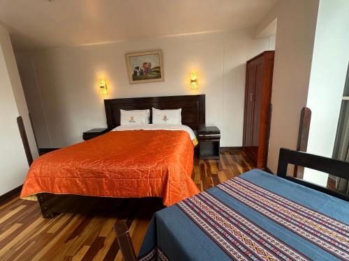 a hotel room with two beds in a room at Hotel Inka Palace Huayna Ccapac Cusco in Cusco