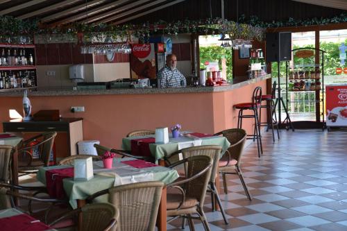 a man standing at the bar of a restaurant at Yavuzhan Hotel in Side