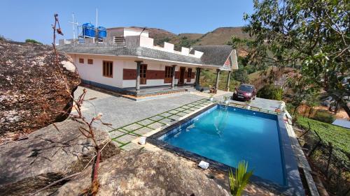 an aerial view of a house with a swimming pool at Wantara Villa in Vagamon
