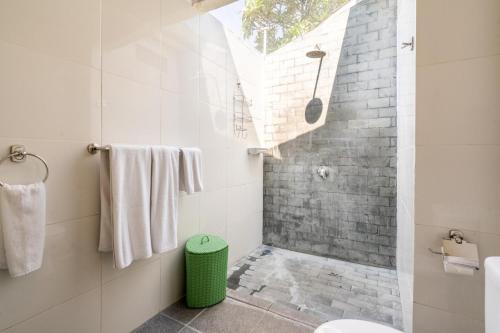 a bathroom with a walk in shower and a toilet at Alinta Villa 1 - Spacious Sanctuary in Sanur