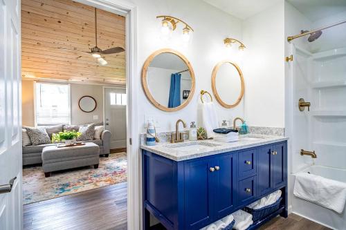 a bathroom with a blue vanity and a living room at Renovated Retreat Home in Huron, close to beaches in Huron