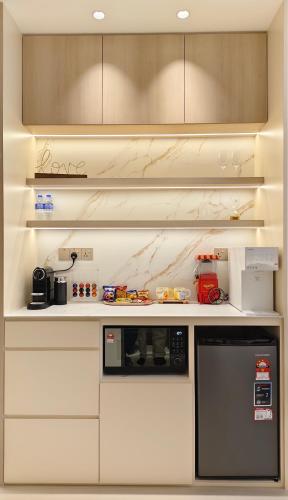 a kitchen with white cabinets and a black microwave at 22 Macalisterz - King Suite - 65"QLED TV - Disney - Pop Corn - Sky Pool in George Town