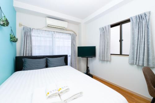 a bedroom with a bed with two books on it at Evergreen hotel ichigaya luxe in Tokyo