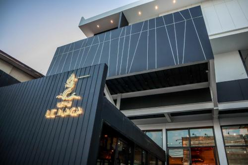 a building with a sign on the side of it at Hotel Le Naga in Sakon Nakhon