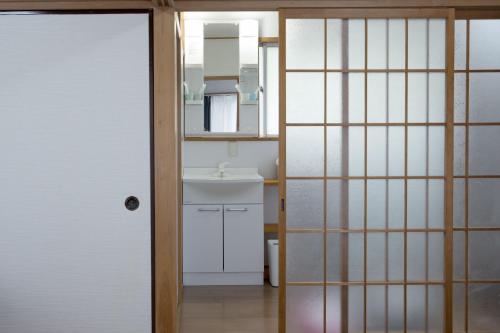 a bathroom with a sink and a mirror at 伊豆の宿 静川 in Ito