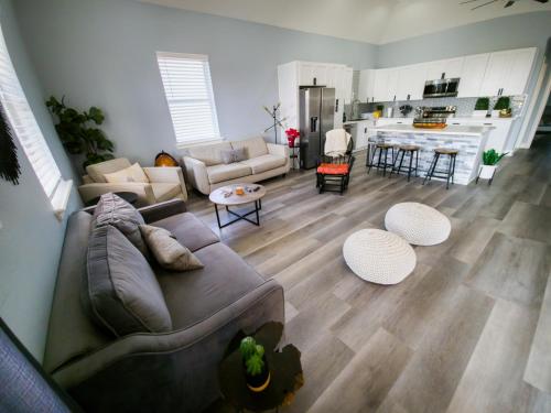a living room with a couch and a kitchen at The Blue House in Hitchcock