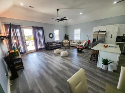 an open living room with a kitchen and a living room at The Blue House in Hitchcock