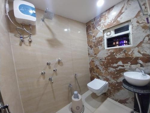 a bathroom with a toilet and a sink at Hotel Sea Touch in Digha