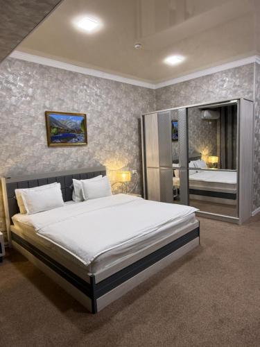 a bedroom with a large bed in a room at HOBIZ Hotel in Navoi