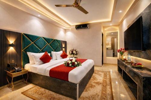 a bedroom with a large bed and a television at Hotel Pearl Plaza - Paharganj - New Delhi in New Delhi