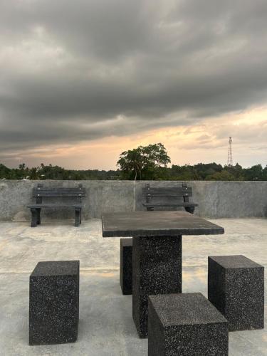 two benches and a table on top of a building at Villa Princess & Apartment in Hikkaduwa