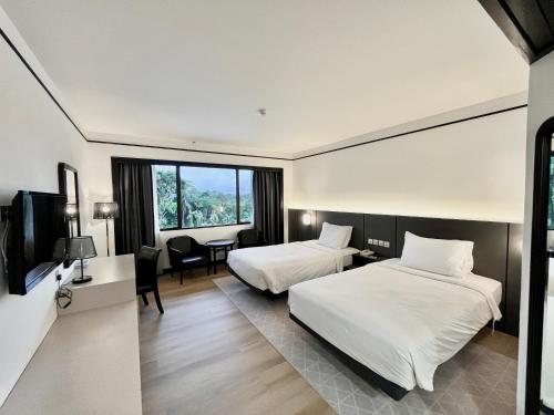 En eller flere senge i et værelse på Sabah Hotel