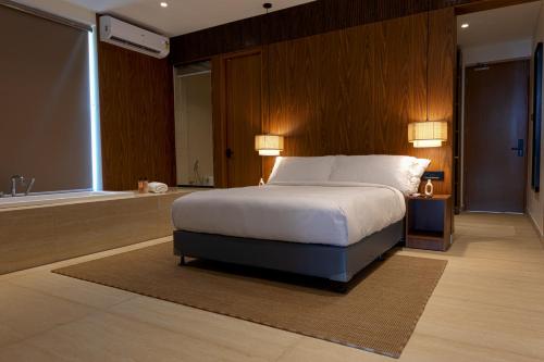 a bedroom with a large bed and a bath room at Sukavi in Paravūr