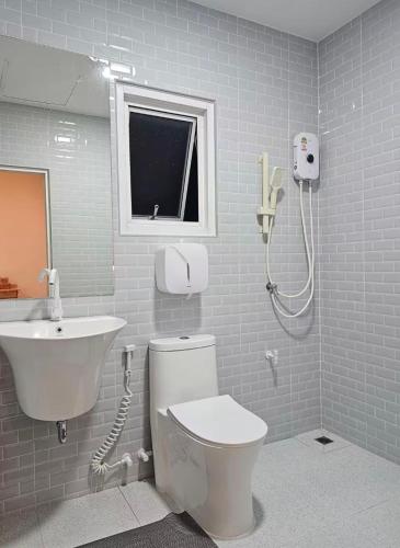 a bathroom with a toilet and a sink at Tee Phak CNX Room D in Chiang Mai