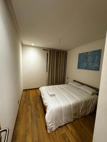 a bedroom with a large white bed in it at Murcia in Rabat