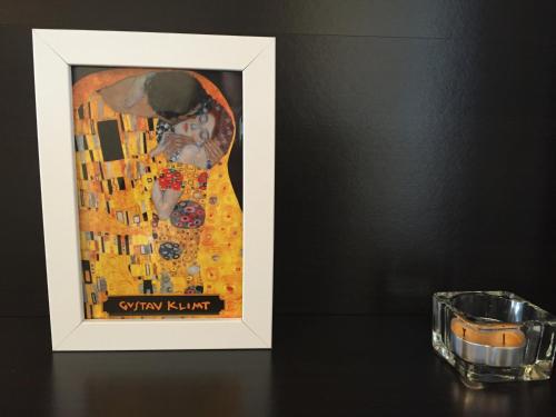 a painting of a woman in a yellow dress next to a glass at Yours Guesthouse in Tongyeong in Tongyeong