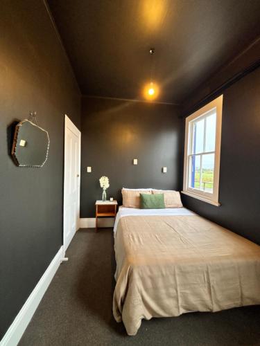 a bedroom with a bed and a window at Rehutai in Wairoa