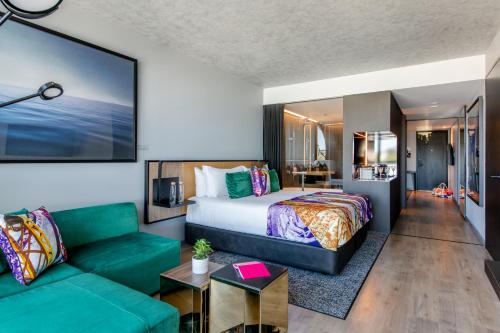 a hotel room with a bed and a couch at Crystalbrook Vincent in Brisbane