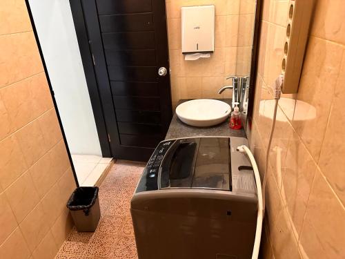 a small bathroom with a toilet and a sink at Telaga Villa Siki in Mantaak
