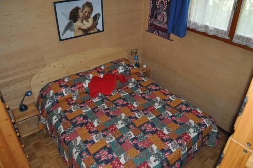 A bed or beds in a room at Rustico nel complesso Chapelle