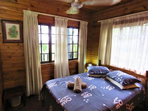 a bedroom with a bed with a stuffed animal on it at Viewpoint Lodge & Safari Tours in Hazyview
