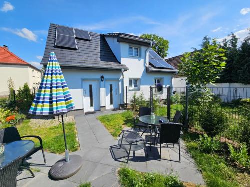 a patio with a table and chairs and an umbrella at Pamir in Ferdinandshof