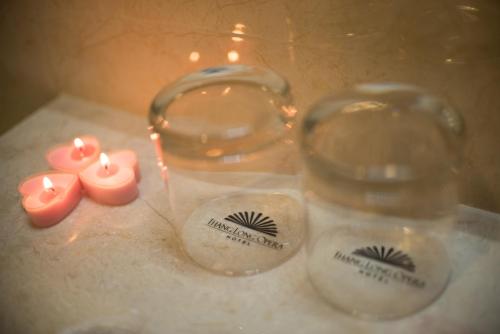 two glass jars with candles on a table at Thang Long Opera Hotel in Hanoi